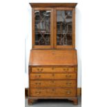 A GEORGE III OAK BUREAU BOOKCASE, THE UPPER PART ENCLOSED BY GLAZED DOORS, 211CM H X 99CM W