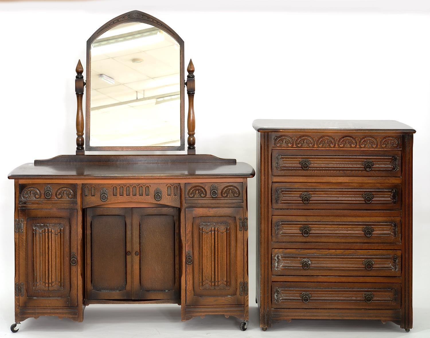 A CARVED OAK BEDROOM SUITE, COMPRISING TWO WARDROBES, CHEST OF DRAWERS, 80CM W, MIRROR BACKED