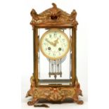 AN ORNATE FRENCH CAST GILTMETAL FOUR GLASS CLOCK, WITH PRIMROSE ENAMEL DIAL, GONG STRIKING MOVEMENT,