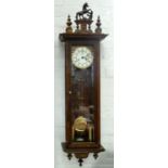 A GERMAN STAINED OAK WALL CLOCK WITH BRASS AND ENAMEL DIAL, 125CM H