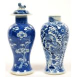 A CHINESE BLUE AND WHITE BALUSTER VASE WITH PRUNUS ON A CRACKED ICE GLAZE AND COVER AND ANOTHER,