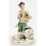 A GERMAN PORCELAIN FIGURE OF A PIPING SHEPHERD, 15CM H, UNDERGLAZE BLUE CROWN AND MONOGRAM, 20TH C