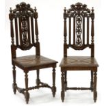 A PAIR OF CHARLES II STYLE CARVED OAK HIGH BACK HALL CHAIRS WITH BOARDED SEATS, 19TH C