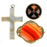 A CARVED AGATE CROSS AND TWO AGATE BROOCHES, ONE IN SILVER, THE OTHER GILT BRASS