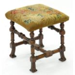 A QUEEN ANNE STYLE WALNUT STOOL ON BRAGANZA FEET, COVERED IN VICTORIAN WOOLWORK, 37 X 37CM, 19TH C