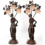 A PAIR OF BRONZED RESIN FIGURAL TABLE LAMPS, WITH THREE CORAL TINTED CHLOROFORM GLASS LAMPSHADES,