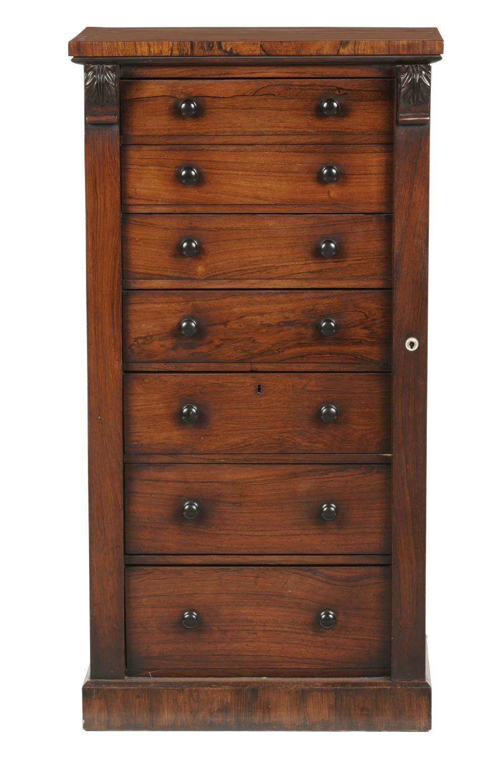 A VICTORIAN ROSEWOOD WELLINGTON CHEST, C1850 the seven graduated drawers with ebony knobs flanked by