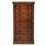 A VICTORIAN ROSEWOOD WELLINGTON CHEST, C1850 the seven graduated drawers with ebony knobs flanked by