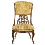 A VICTORIAN ROSEWOOD NURSING CHAIR, C1870  with buttoned upper and lower carved openwork back,