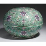 A CHINESE TURQUOISE GROUND FAMILLE ROSE ROUND BOX AND COVER  enamelled with stylised lotus and