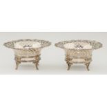 TWO GEORGE V TRELLIS PIERCED SILVER BASKETS  with shells to the rim, on four feet, crested, 15.5cm