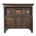 AN ANTIQUARIAN TASTE CARVED OAK LIVERY CUPBOARD, 17TH C AND LATER  the centre panel and those to the