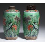 A PAIR OF CHINESE GREEN GROUND FAMILLE VERTE JARS painted with peony and rocks between diaper and