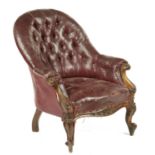A VICTORIAN CARVED WALNUT ARMCHAIR UPHOLSTERED IN EARLY BUTTONED MAROON LEATHERCLOTH, C1870  seat