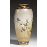 A JAPANESE SATSUMA EARTHENWARE VASE, MEIJI PERIOD enamelled to one side with a jay on blossoming