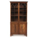 A MAHOGANY BOOKCASE, 19TH C  the upper part with dentil cornice above lancet arched glazed doors