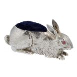 AN EDWARD VII SILVER RABBIT NOVELTY PIN CUSHION  with pink glass eyes, 5.6cm, by Adie & Lovekin Ltd,