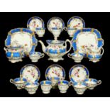 A COALPORT TEA AND COFFEE SERVICE, C1830 painted with roses and other flowers in blue border, teapot