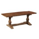 AN OAK TABLE  the single plank burr oak top with cleated ends on two squared baluster end supports