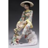 AN ITALIAN EARTHENWARE FIGURE OF AN ASIAN GIRL WITH A BASKET OF FISH, MID 20TH C  the face, hands