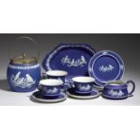 A SET OF THREE WEDGWOOD DARK BLUE BAS RELIEF WARE CUPS, SAUCERS AND PLATES, MILK JUG, DISH AND