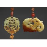 TWO CHINESE CELADON AND RUSSET JADE PENDANTS, 20TH C  one with phoenix and bat, 5.8cm h, silk