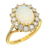 AN OPAL AND DIAMOND CLUSTER RING in 18ct gold, the central opal approx 10 x 8 mm, 6.5g, size N Light