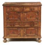 A WILLIAM III GEOMETRIC MOULDED OAK CHEST OF DRAWERS, C1700   on bun feet, the sides panelled, 91cm