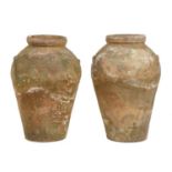 TWO MATCHING ITALIAN TERRACOTTA OIL JARS, 19TH C  with vestigial handles, 79cm h, impressed shield