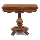 A VICTORIAN ROSEWOOD CARD TABLE, C1850 on octagonal pillar and round lappeted base with paw feet,