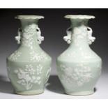 A PAIR OF CHINESE CELADON GROUND VASES, CANTON, C1900 enamelled in white with lotus, prunus, peach