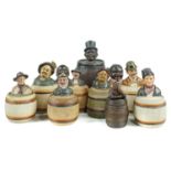 ELEVEN GERMAN COLD PAINTED FIGURAL TERRACOTTA TOBACCO JARS AND COVERS, LATE 19TH-EARLY 20TH C  of