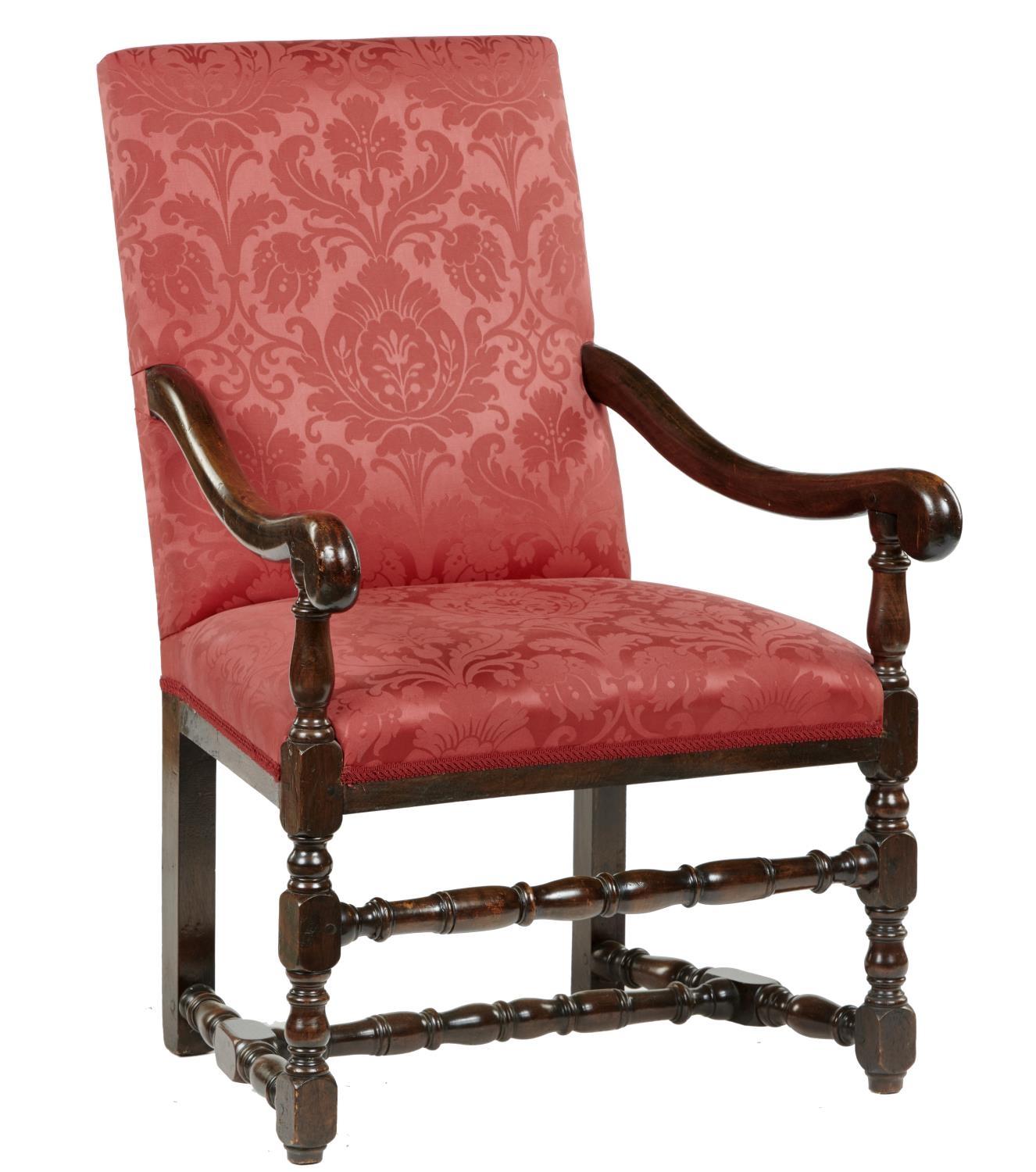 A 17TH C STYLE WALNUT ARMCHAIR  with baluster supports and cross stretchers, upholstered in