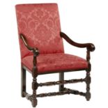 A 17TH C STYLE WALNUT ARMCHAIR  with baluster supports and cross stretchers, upholstered in