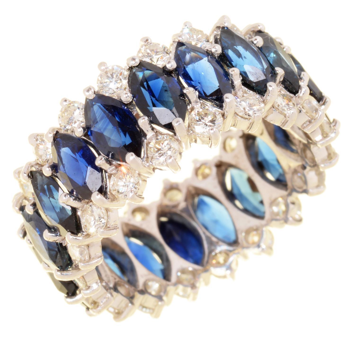 A SAPPHIRE AND DIAMOND ETERNITY RING with marquise sapphires, in white gold, 10g, size R In good