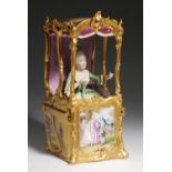 A CONTINENTAL PORCELAIN FIGURE OF AN 18TH CENTURY LADY IN A GILT SEDAN CHAIR, C1900  painted with