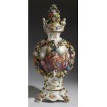 A POTSCHAPPEL FLORAL AND FRUIT ENCRUSTED PORCELAIN VASE, COVER AND STAND, EARLY 20TH C  painted with