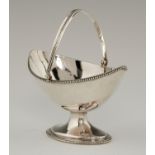 A GEORGE III SILVER SUGAR BASKET  with reeded handle and beaded rim, 14cm h, by Hester Bateman,