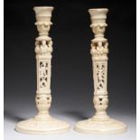 A PAIR OF WEDGWOOD PIERCED IVORY TINTED BONE CHINA CANDLESTICKS, C1890 25cm h, printed mark, shape