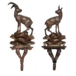 A PAIR OF SWISS CARVED AND STAINED LIMEWOOD MODELS OF MOUNTAIN GOATS AND WALL BRACKETS, LATE 19TH C