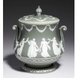 A WEDGWOOD GREEN JASPER DIPPED STONEWARE BISCUIT BARREL AND COVER, C1890 ornamented with the Dancing