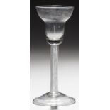 AN ENGLISH WINE GLASS  the pan topped round funnel bowl on incised twist stem and folded foot, 15.