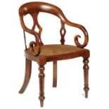 A VICTORIAN MAHOGANY ELBOW CHAIR, C1850 with three pierced splats and overscrolled arms, caned seat,