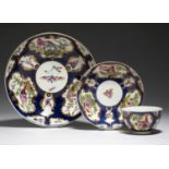 A WORCESTER SCALE BLUE GROUND TEA BOWL, SAUCER AND SAUCER DISH, C1770 painted with dishevelled and