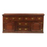 A GEORGE III OAK DRESSER,  NORTH WALES, EARLY 19TH C  the moulded top above an arrangement of