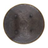 AN INDIAN STEEL SHIELD, DHAL, FIRST HALF 19TH C  with four bosses and brass rim, 51cm diam Old