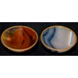 A PAIR OF BOUCHERON GOLD MOUNTED AND TURNED AGATE PIN TRAYS, EARLY 20TH C  6cm diam, tete d'aigle