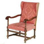 A WALNUT WING ARMCHAIR, C1690 on barley twist supports and cross stretchesr, upholstered in