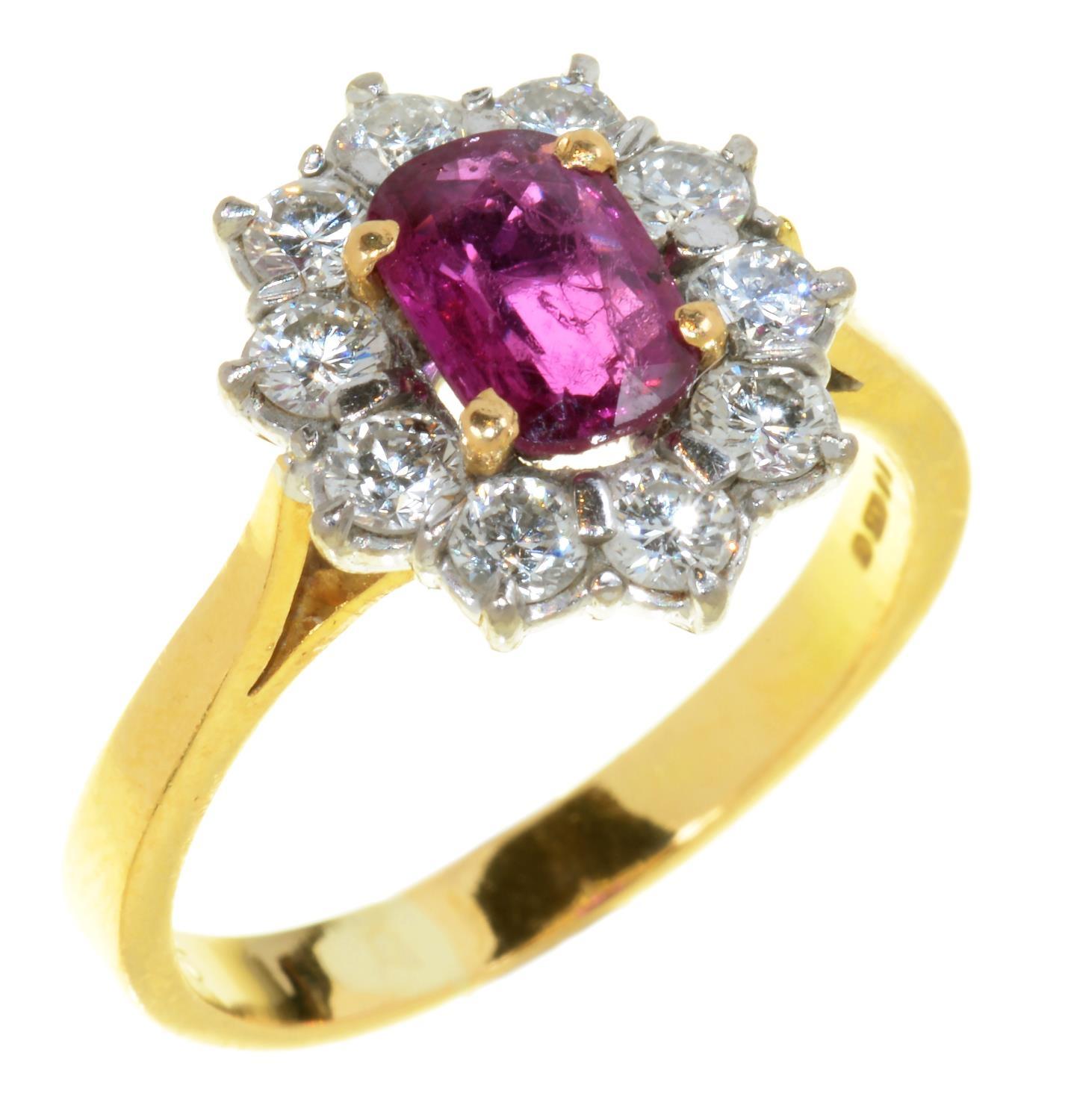 A RUBY AND DIAMOND CLUSTER RING in 18ct gold, London 1983, 3.5g, size M Good condition