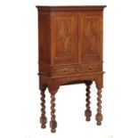 A GEORGE V OAK AND BROWN OAK STATIONERY CABINET, EARLY 20TH C with carved cornice and dentil frieze,